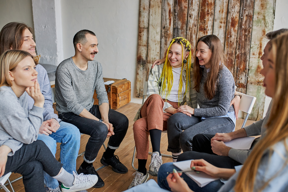 A person hands a bag of food to a child in a crowded street, emphasizing kindness amidst a bustling urban setting